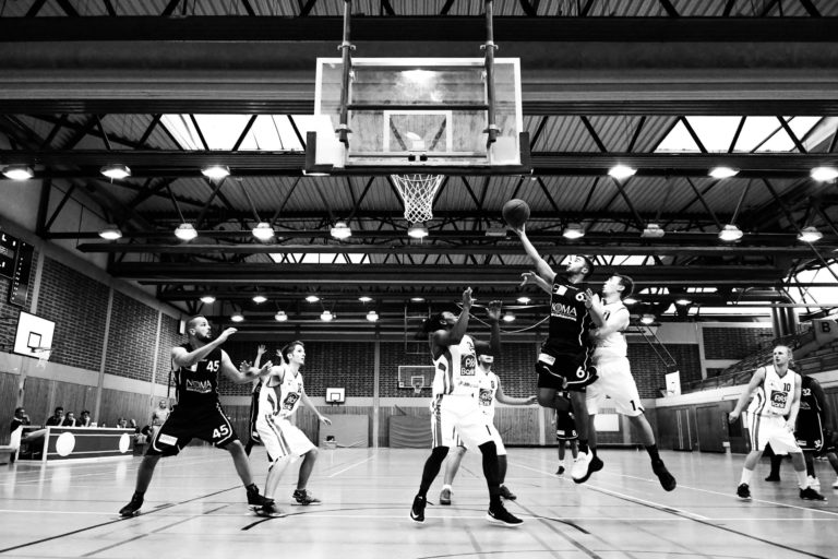 Foto em P&B de jogadores de basquete em ação